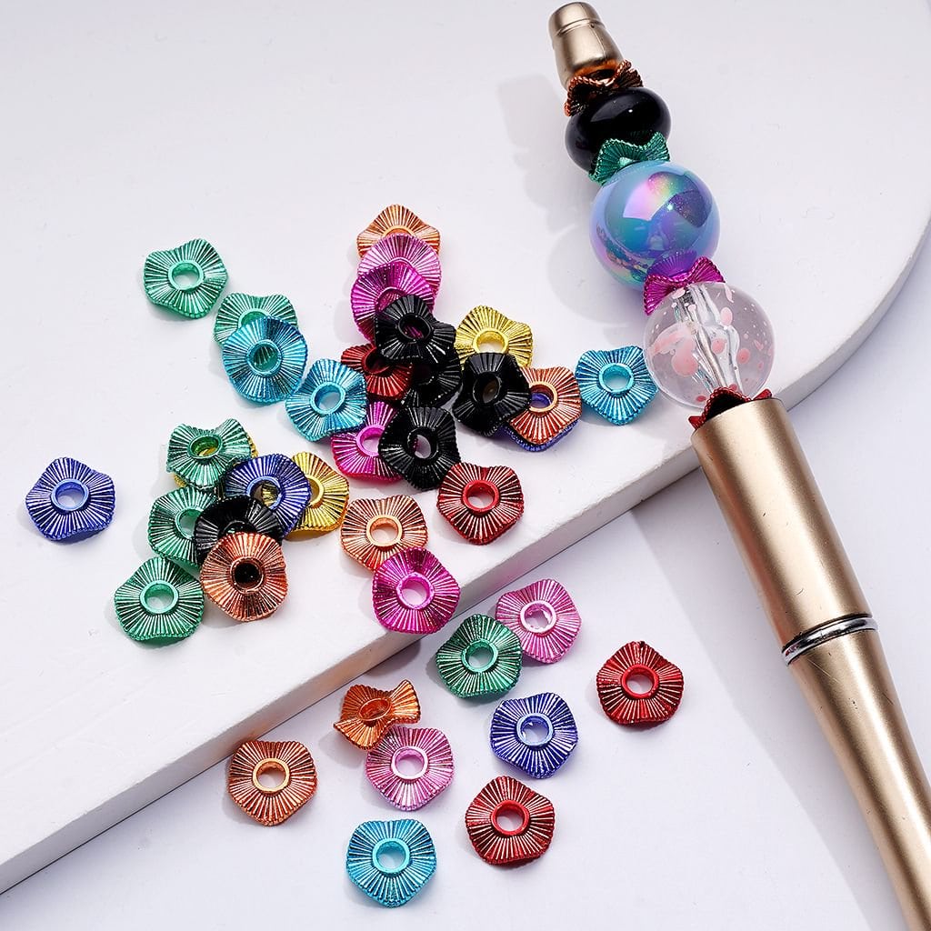 Colorful decorative elements on a white surface with a pen.

