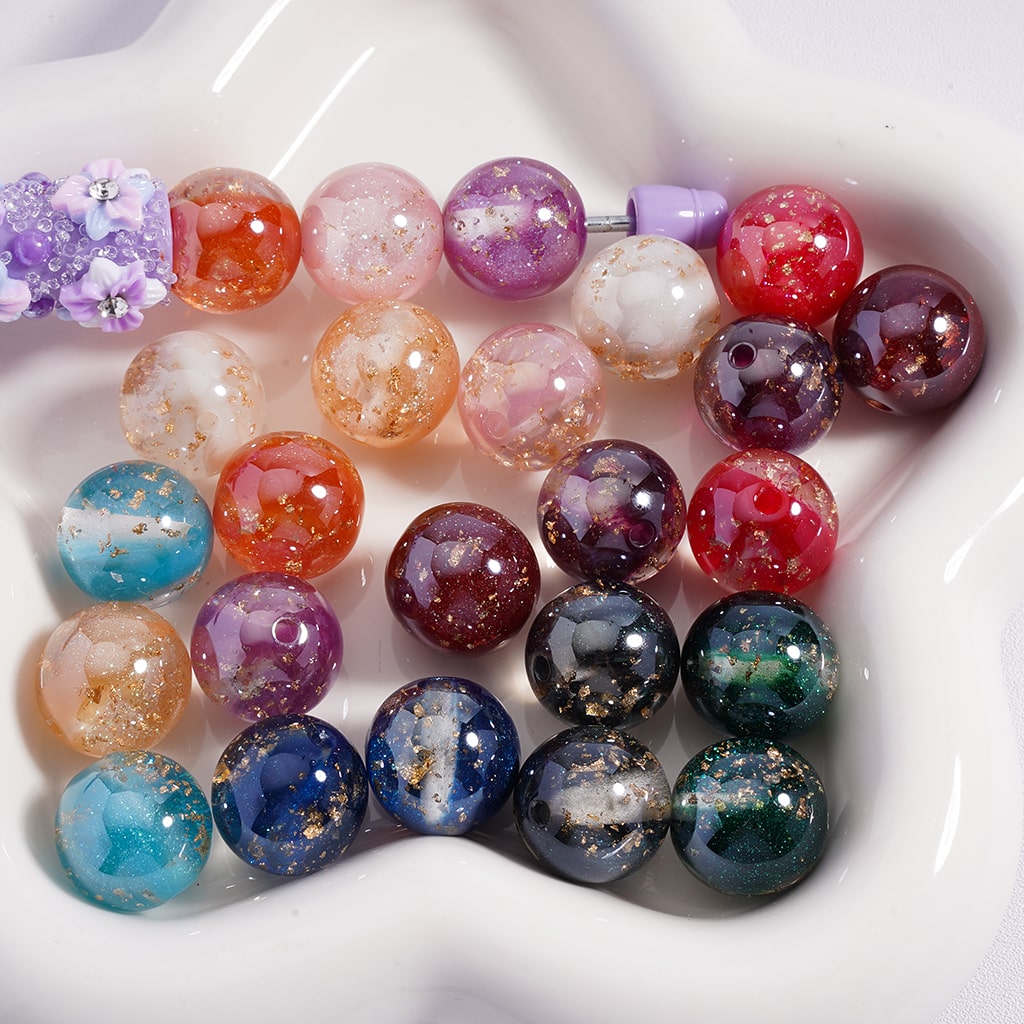 Assorted colored beads on a white dish

