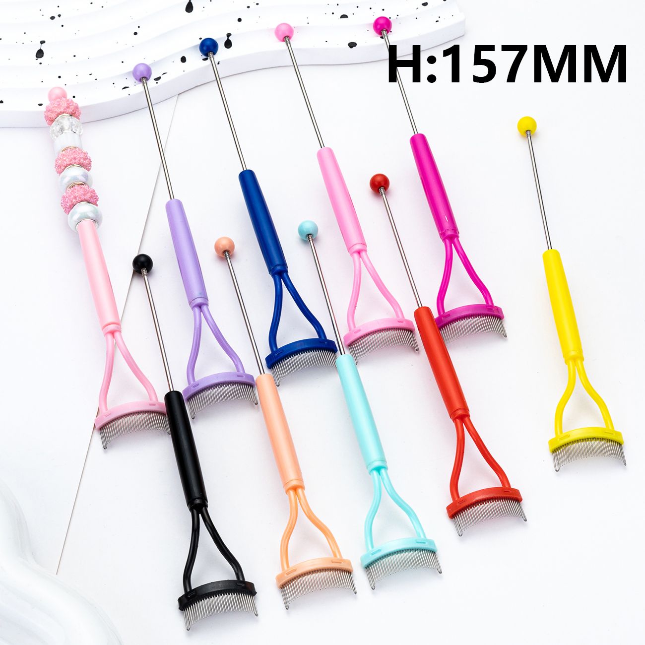 Set of colorful pet grooming tools with handles on a white background


