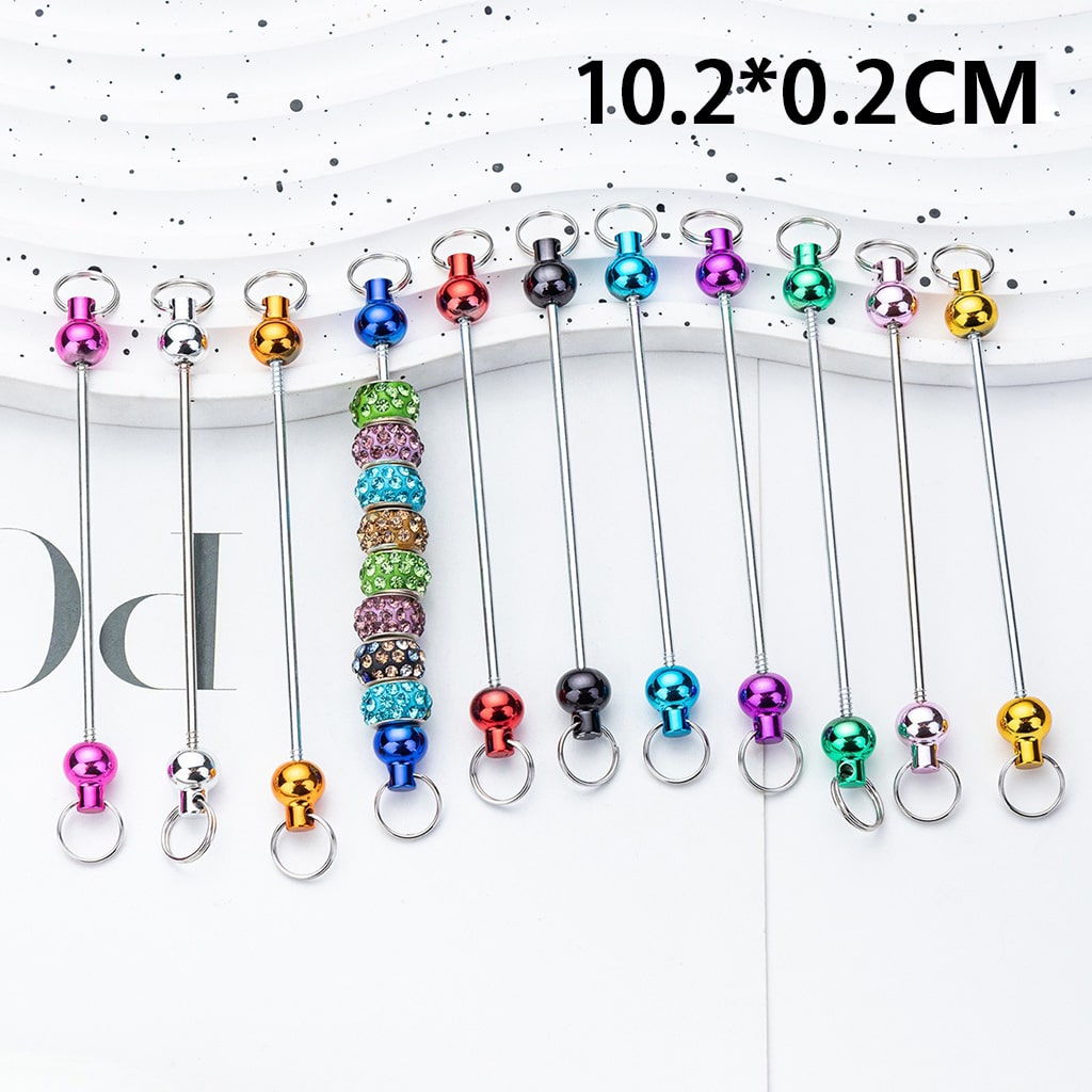 Set of colorful metal keys with beads on a white background

