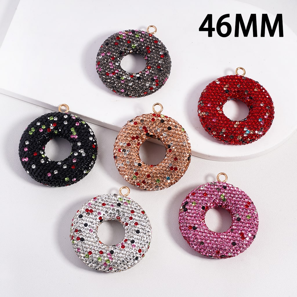 Set of six donut-shaped jewelry pendants with rhinestones on a white background, labeled '46MM'.

