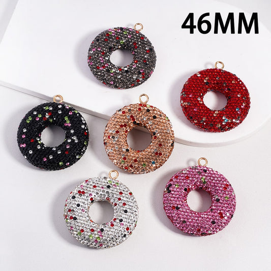 Set of six donut-shaped jewelry pendants with rhinestones on a white background, labeled '46MM'.

