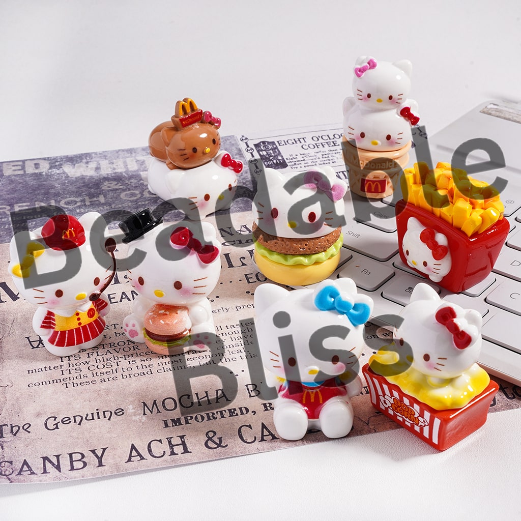 Set of Hello Kitty-themed snack figurines on a newspaper background

