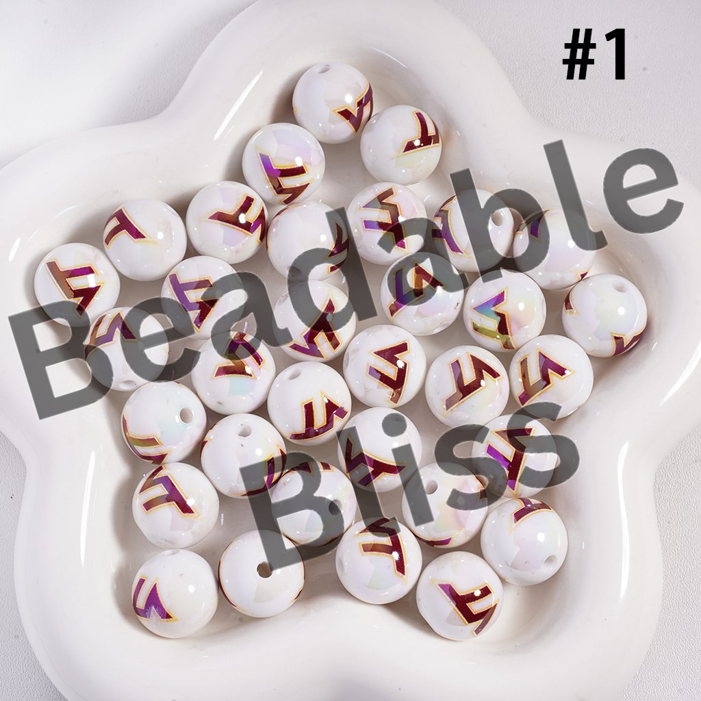 White beads with letter designs on a white plate, branded 'Beadable Bliss'.

