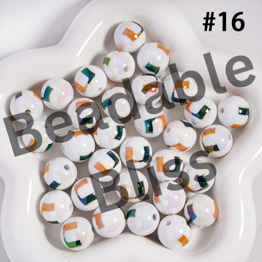 White beads with colorful patterns on a white plate, labeled 'Beadable Bliss'.

