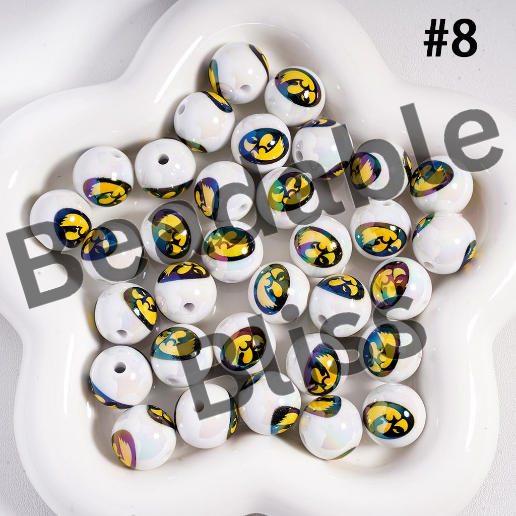 White beads with colorful patterns on a white plate, labeled 'Beadable Beads'.

