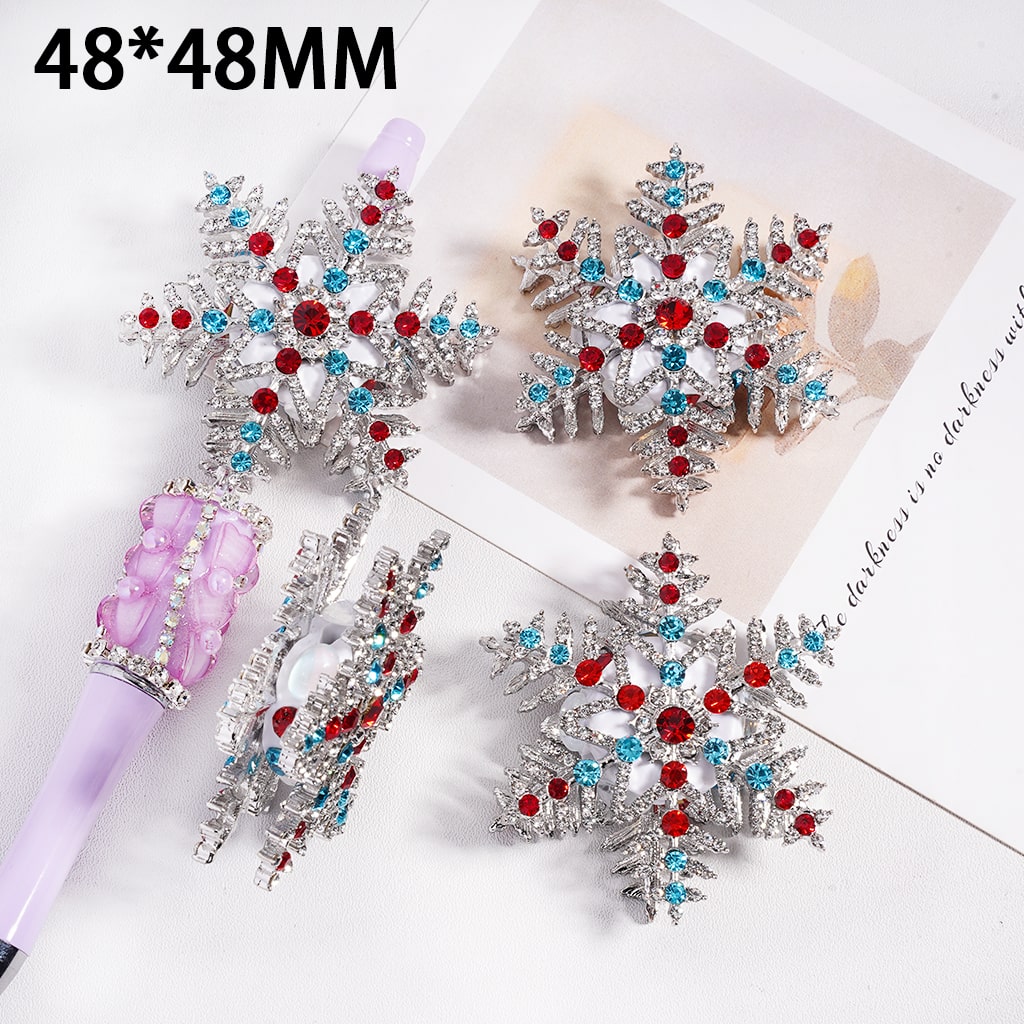 Decorative hair clips with snowflake designs and colorful gemstones on a white background.

