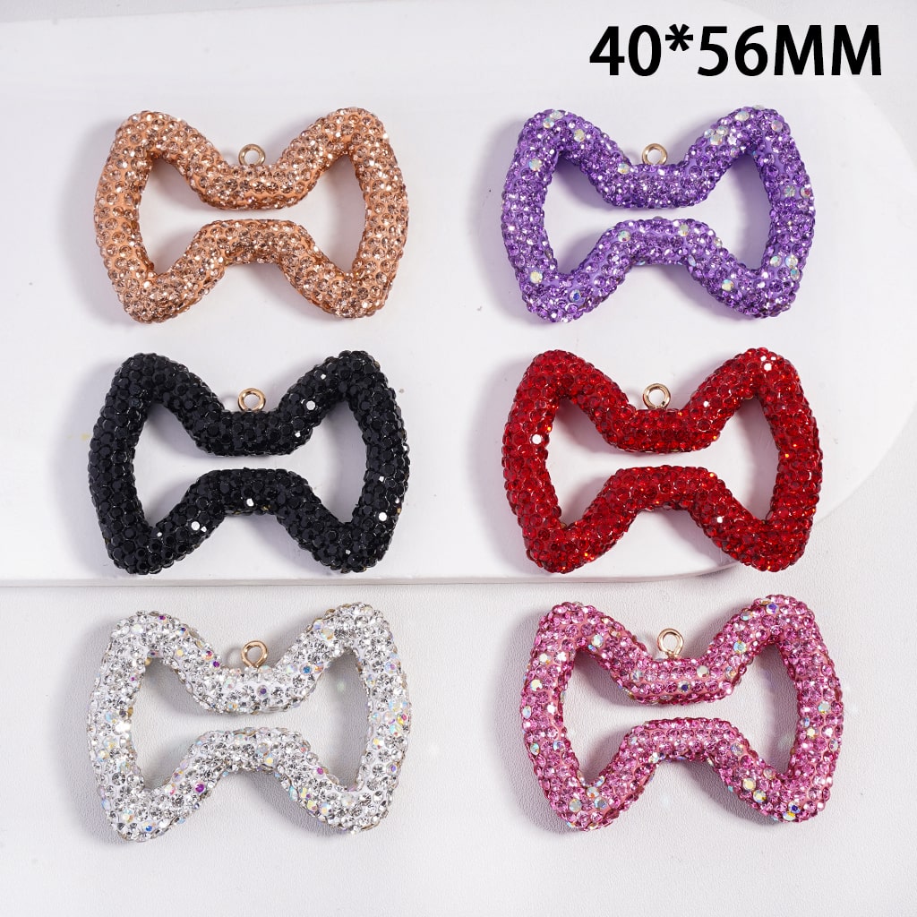 Set of six glittery bow-shaped accessories in different colors on a white background.
