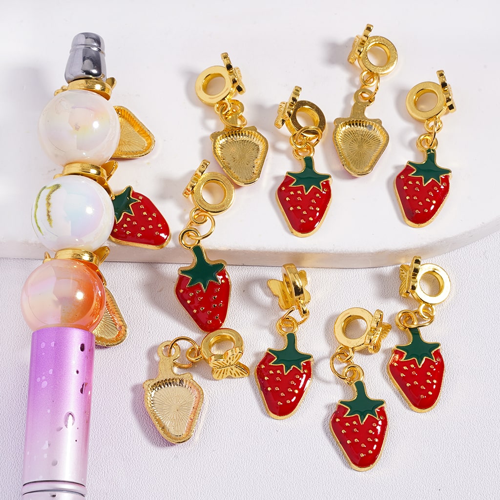Strawberry-shaped charms on a white background