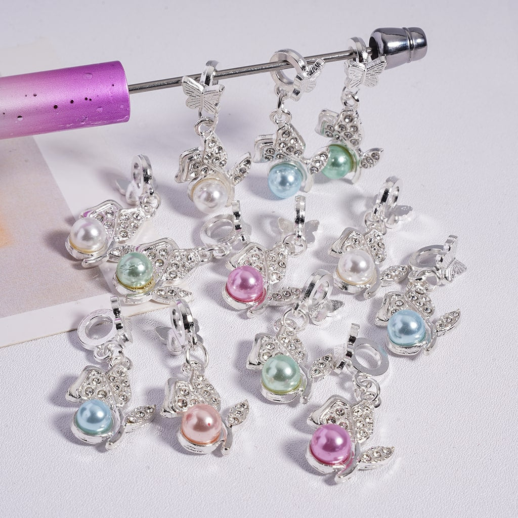 Decorative charms with pearls and butterflies on a white background