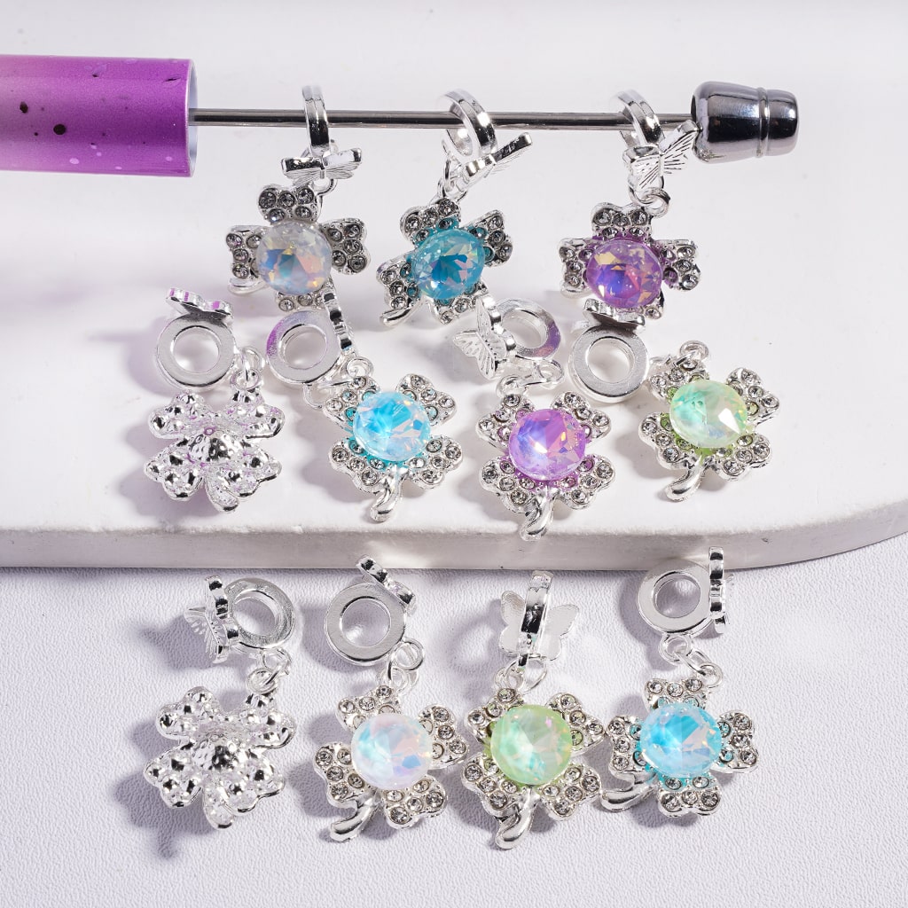 Belly button ring with colorful gemstone charms on a white background