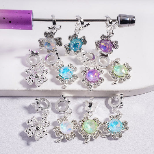 Belly button ring with colorful gemstone charms on a white background