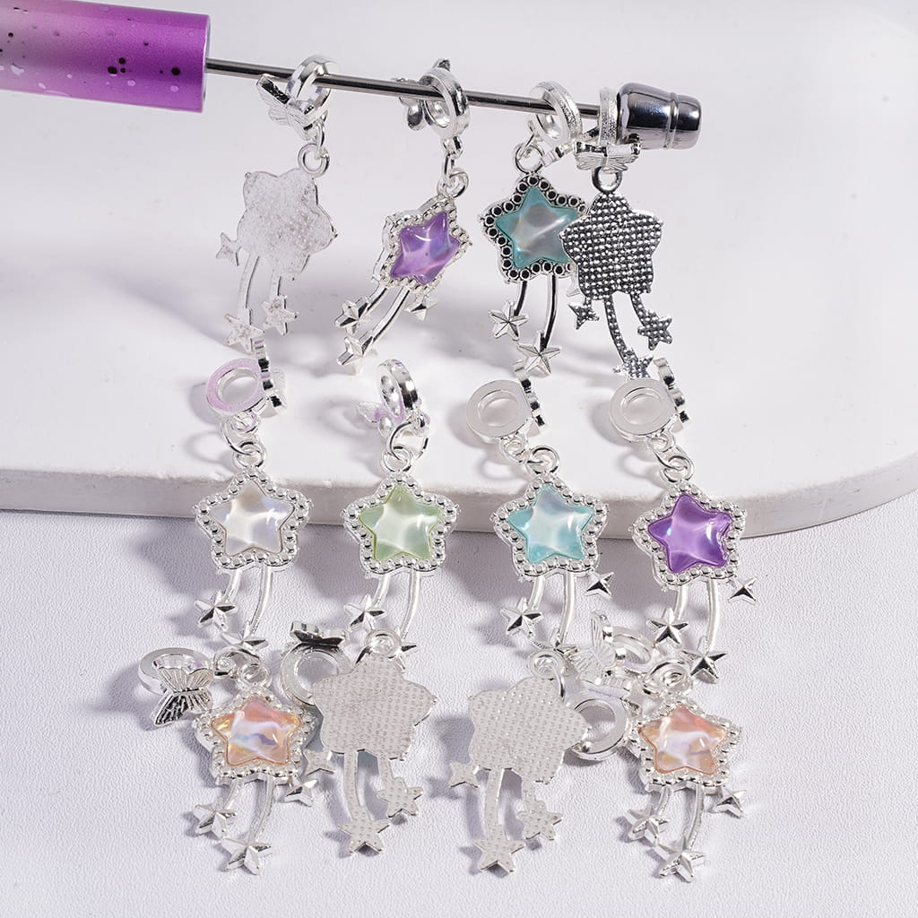 Pair of earrings with star-shaped charms on a white background

