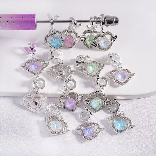 Set of decorative charms with gemstones on a white background