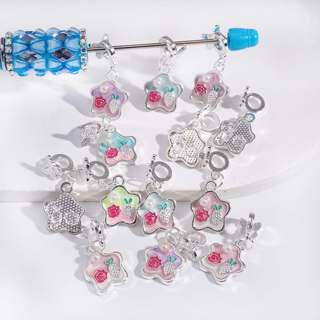 Bracelet with floral and star-shaped charms on a white background
