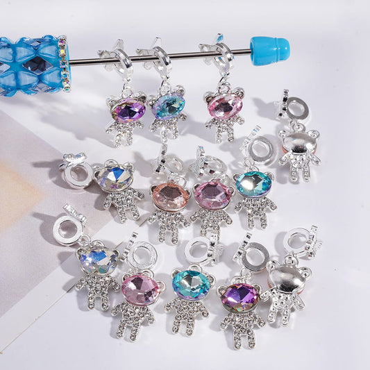 Collection of colorful cat-shaped charms on a white background